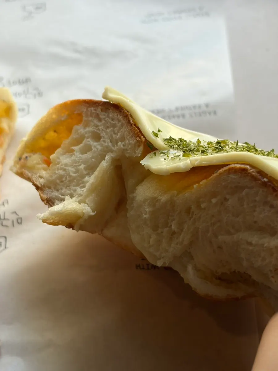 A piece of potato bagel with iced Americano