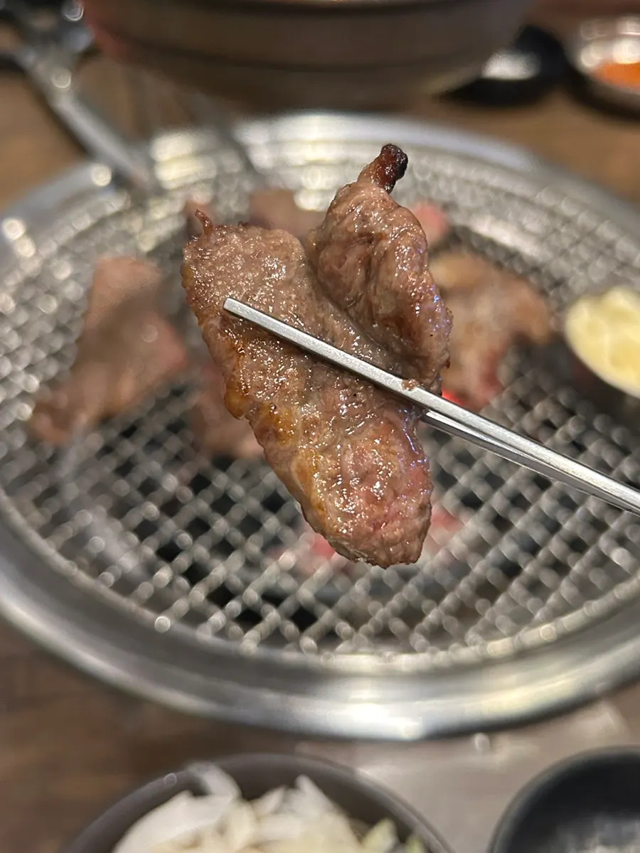 Rib meat turning golden-brown on the grill