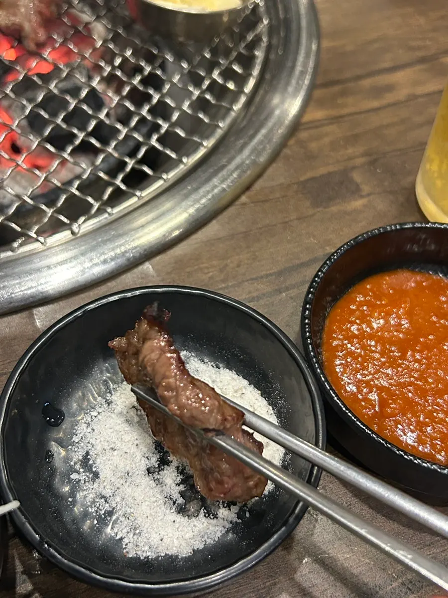 First piece of rib meat dipped in salt