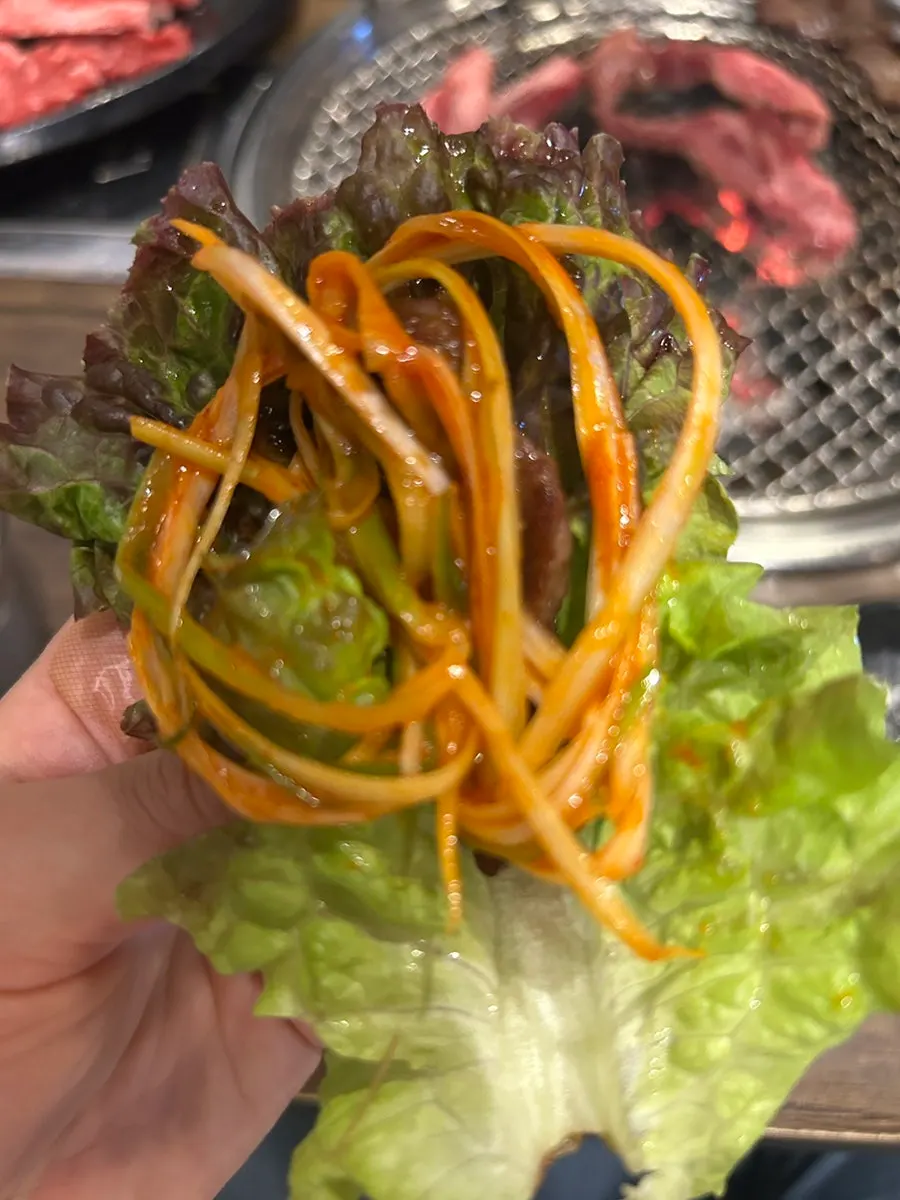 Grilled rib meat served with scallion salad