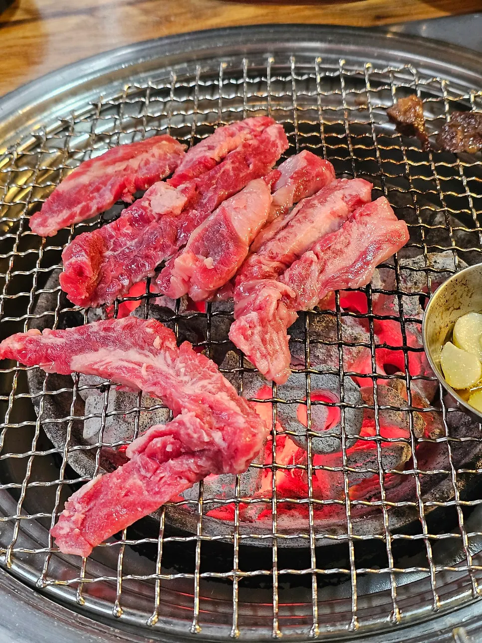 Beef ribs added to the charcoal grill in small batches