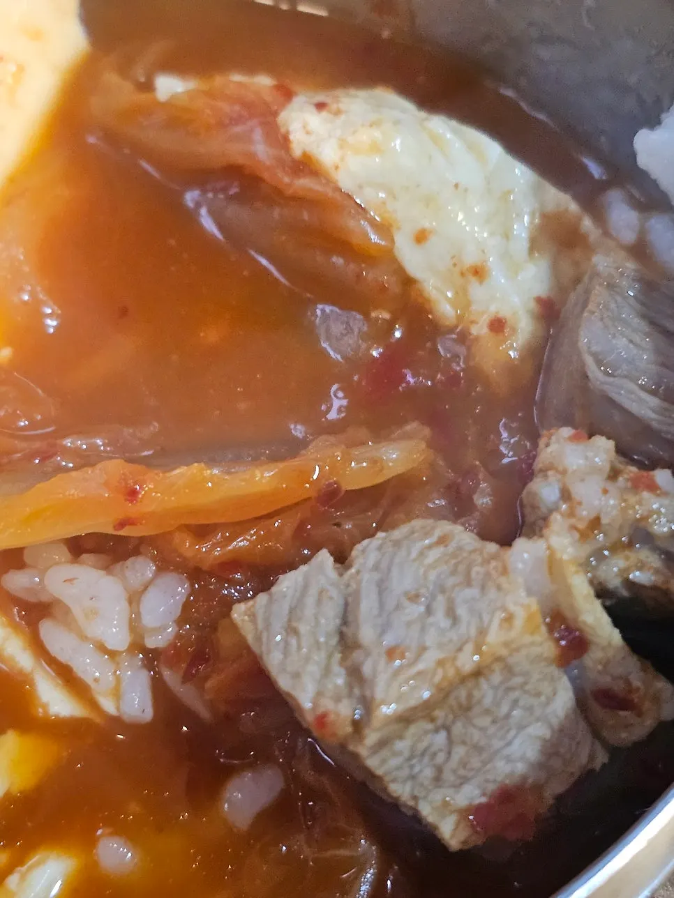 Eating the kimchi stew with added rice