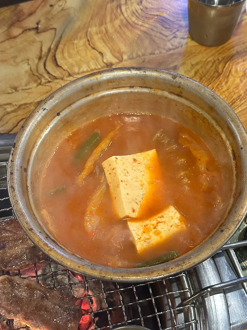 Pork kimchi stew served in a metal bowl