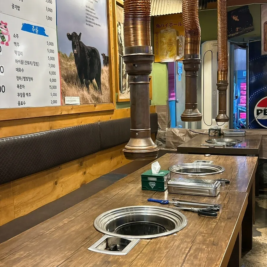 A table at Mapo Mokjang with the charcoal grill lit