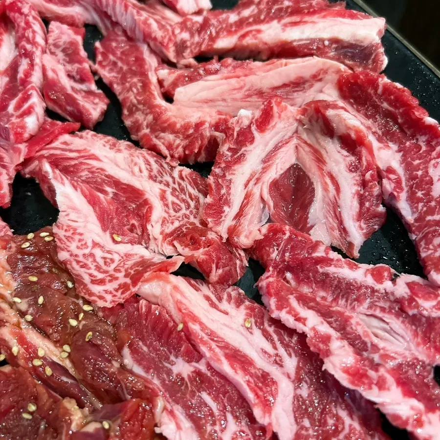 Plate of marinated rib meat sprinkled with sesame seeds