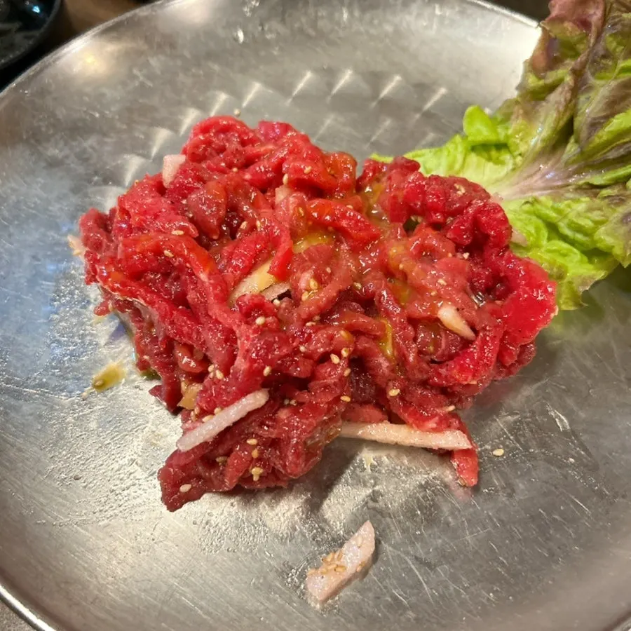 Egg yolk placed in the center of the beef tartare