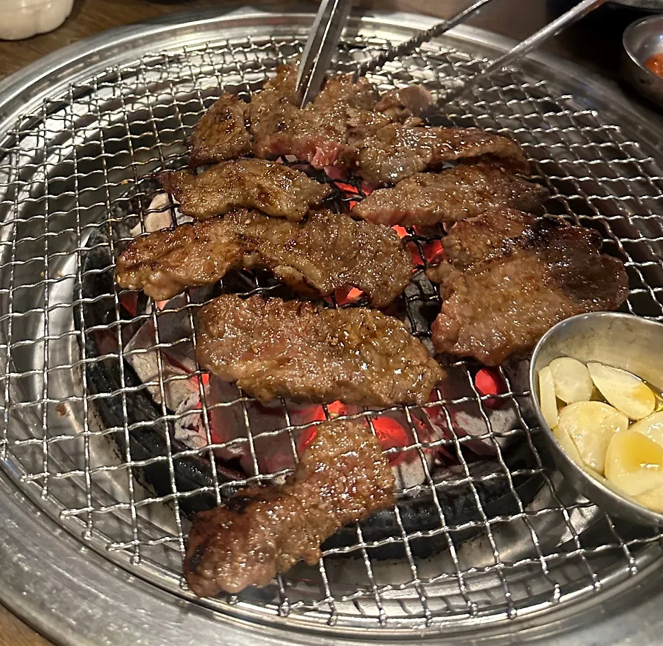 Garlic grilled on its own plate over Mapo Mokjang's charcoal fire