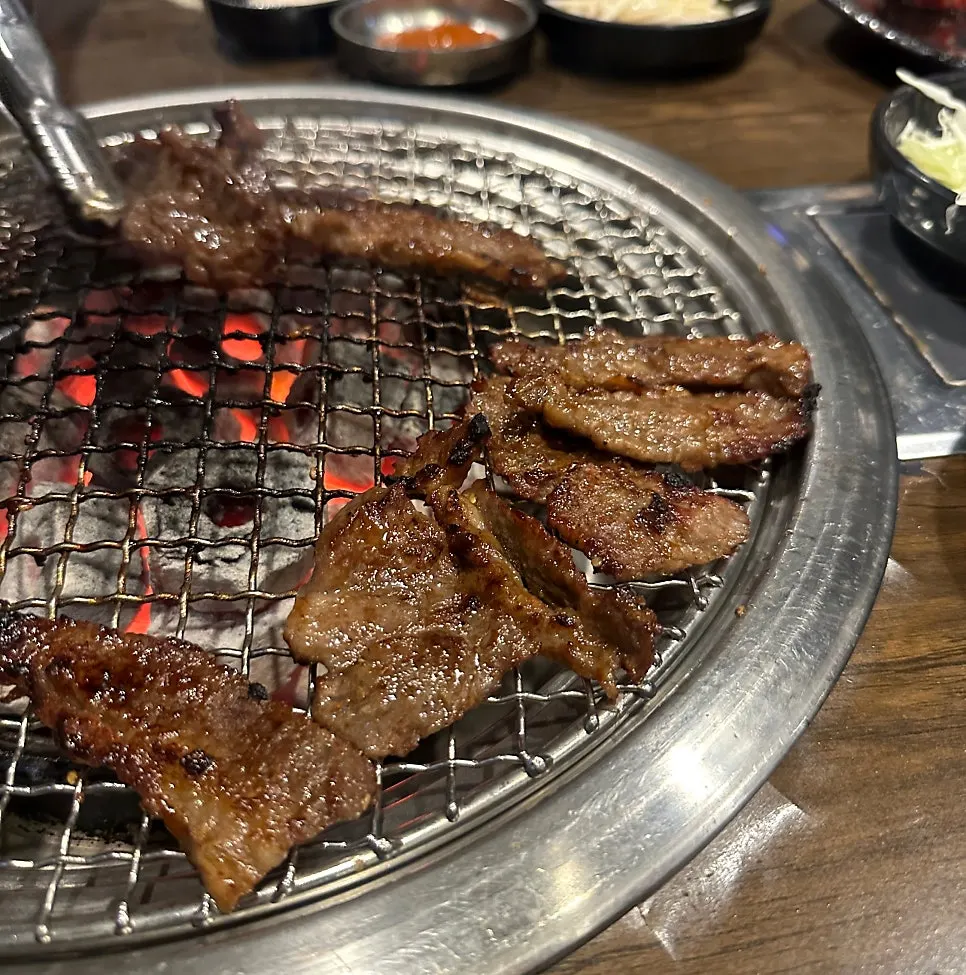 A grilled beef rib piece placed over white rice