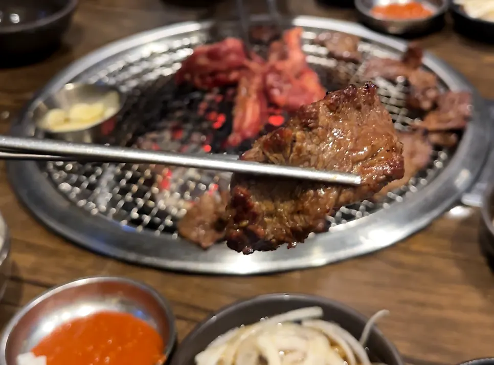 Marinated rib meat and side dishes cooking on the grill