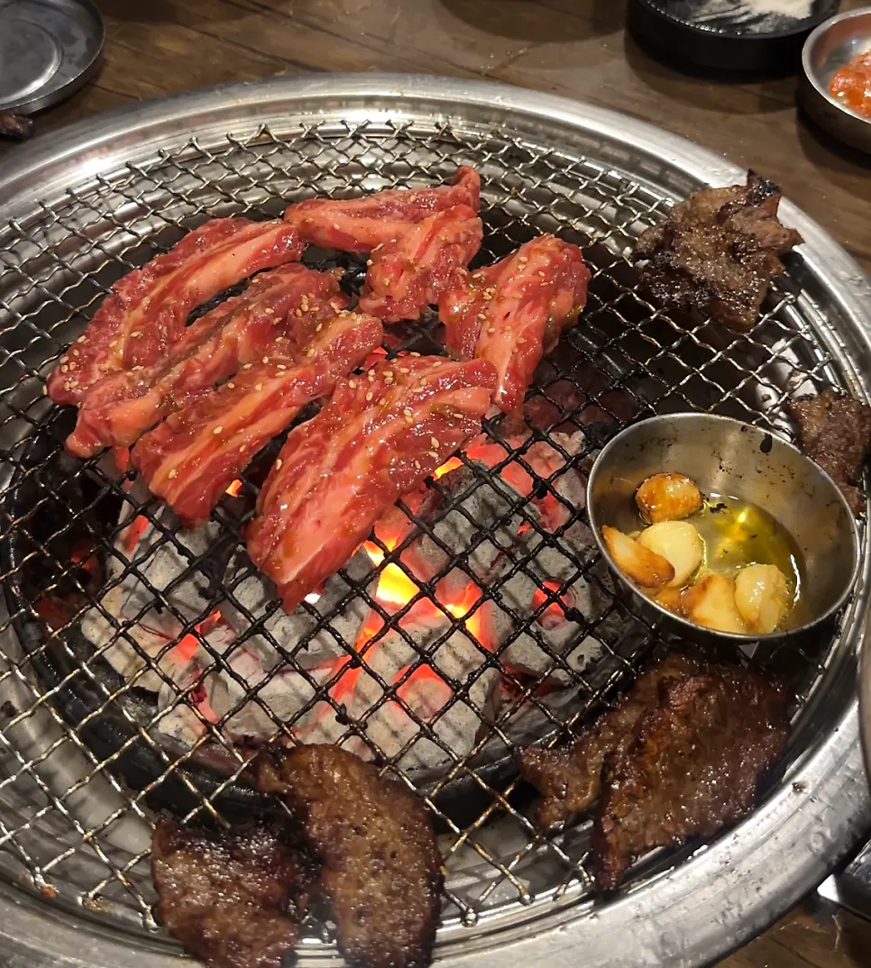 Grilled beef placed on a lettuce wrap with sides