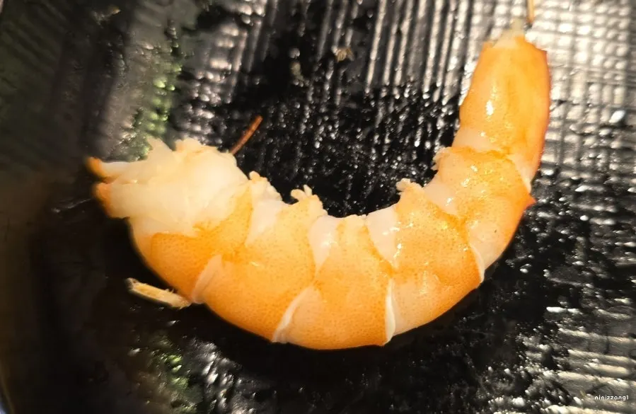 A plate of raw shrimp sashimi