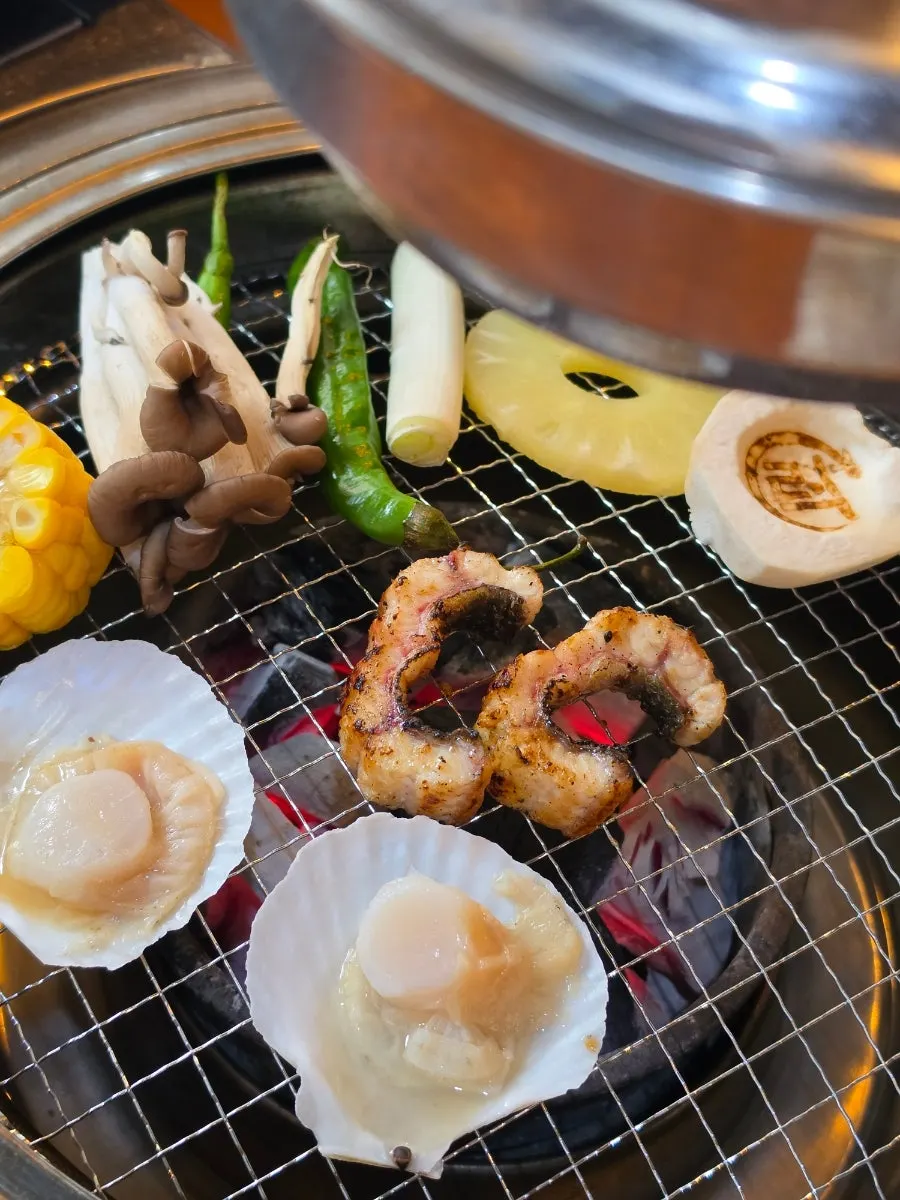 A full spread of eel grilling on the tabletop grill