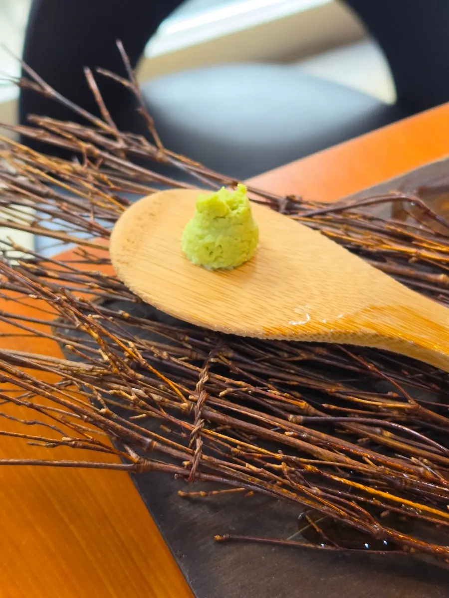 Eel grilling alongside pineapple and mushrooms