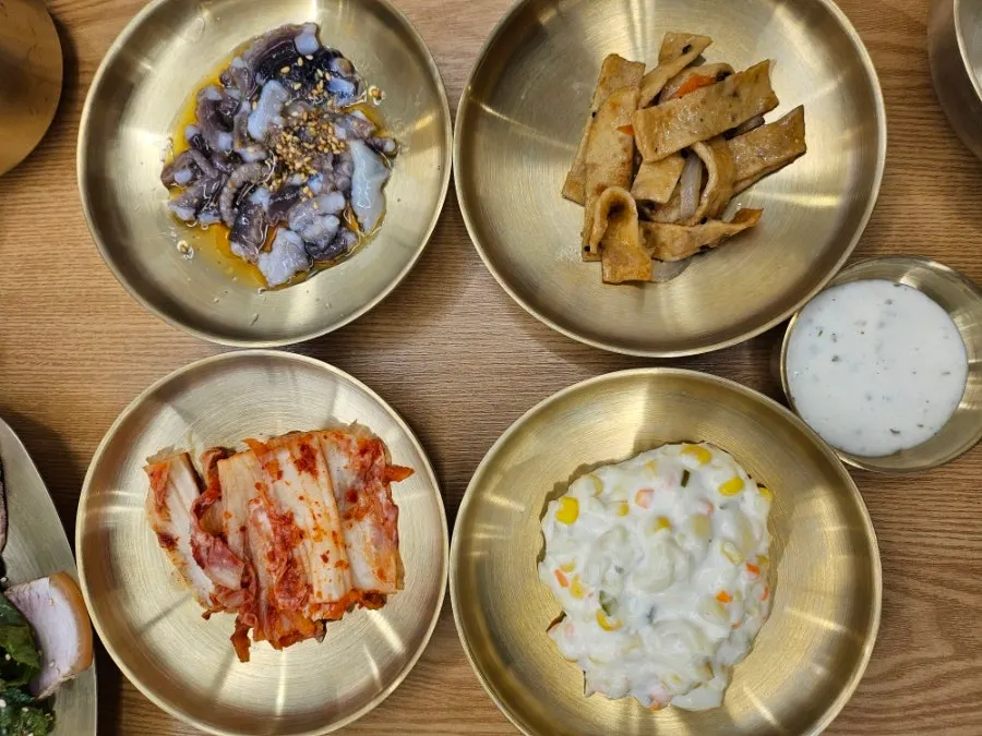Basic side dishes including fish cake, corn salad, and kimchi