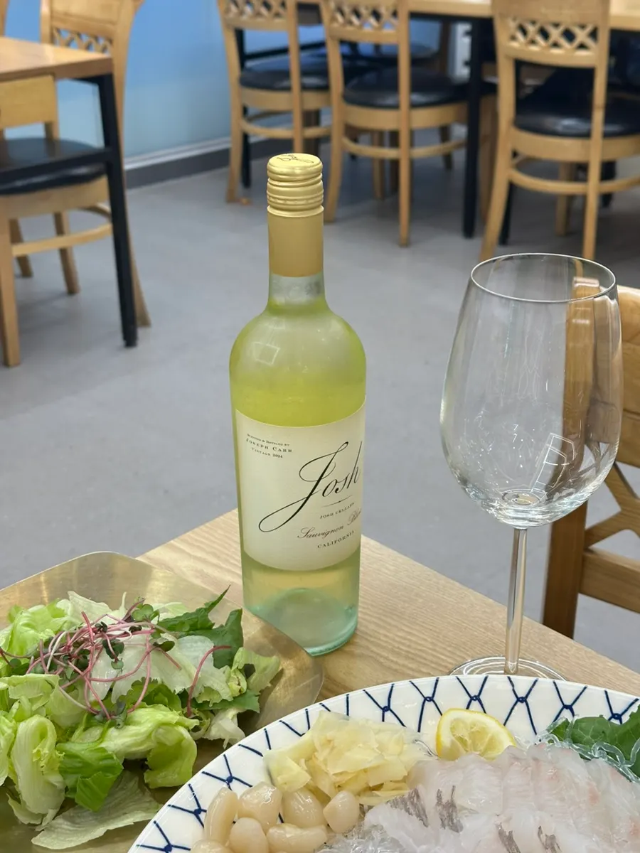 A glass of Sauvignon Blanc set beside the seafood