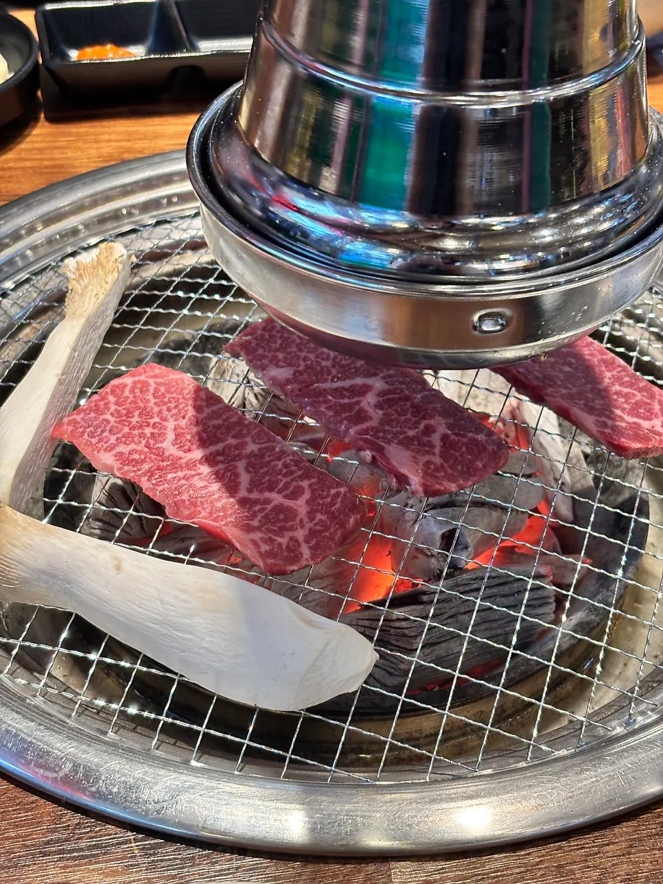 Beef grilling over charcoal