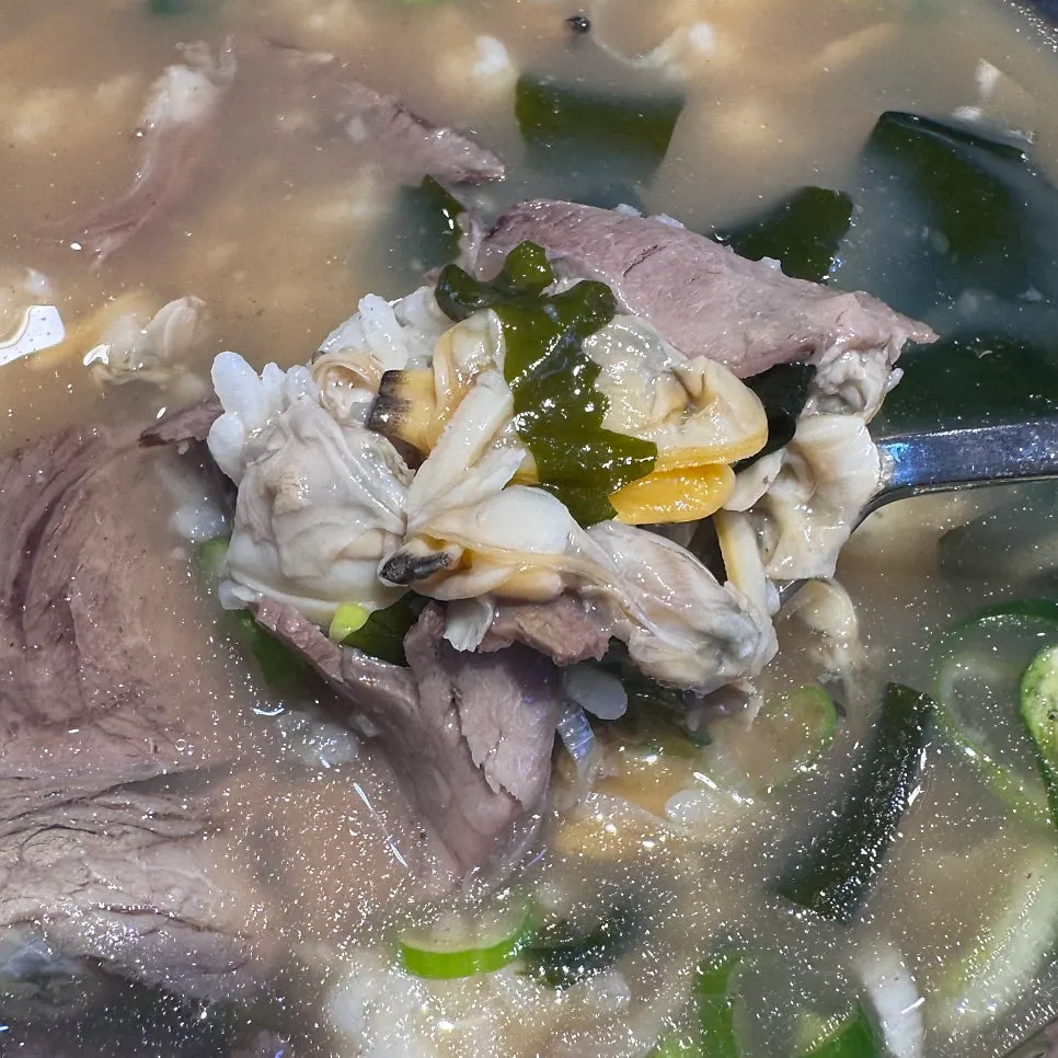 Fresh clam beef gukbap topped with clams and beef