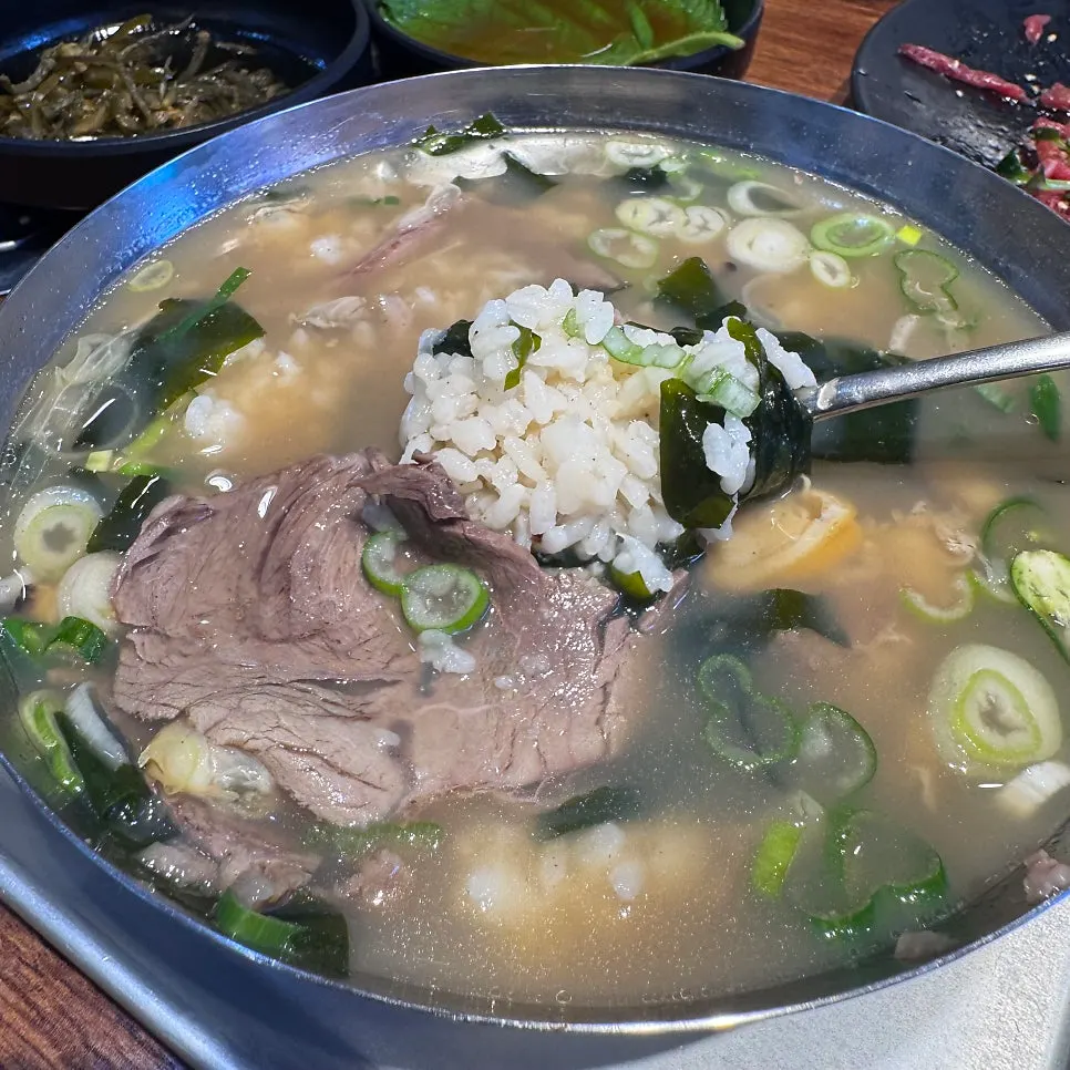 Fresh clam beef gukbap with rice already in the bowl