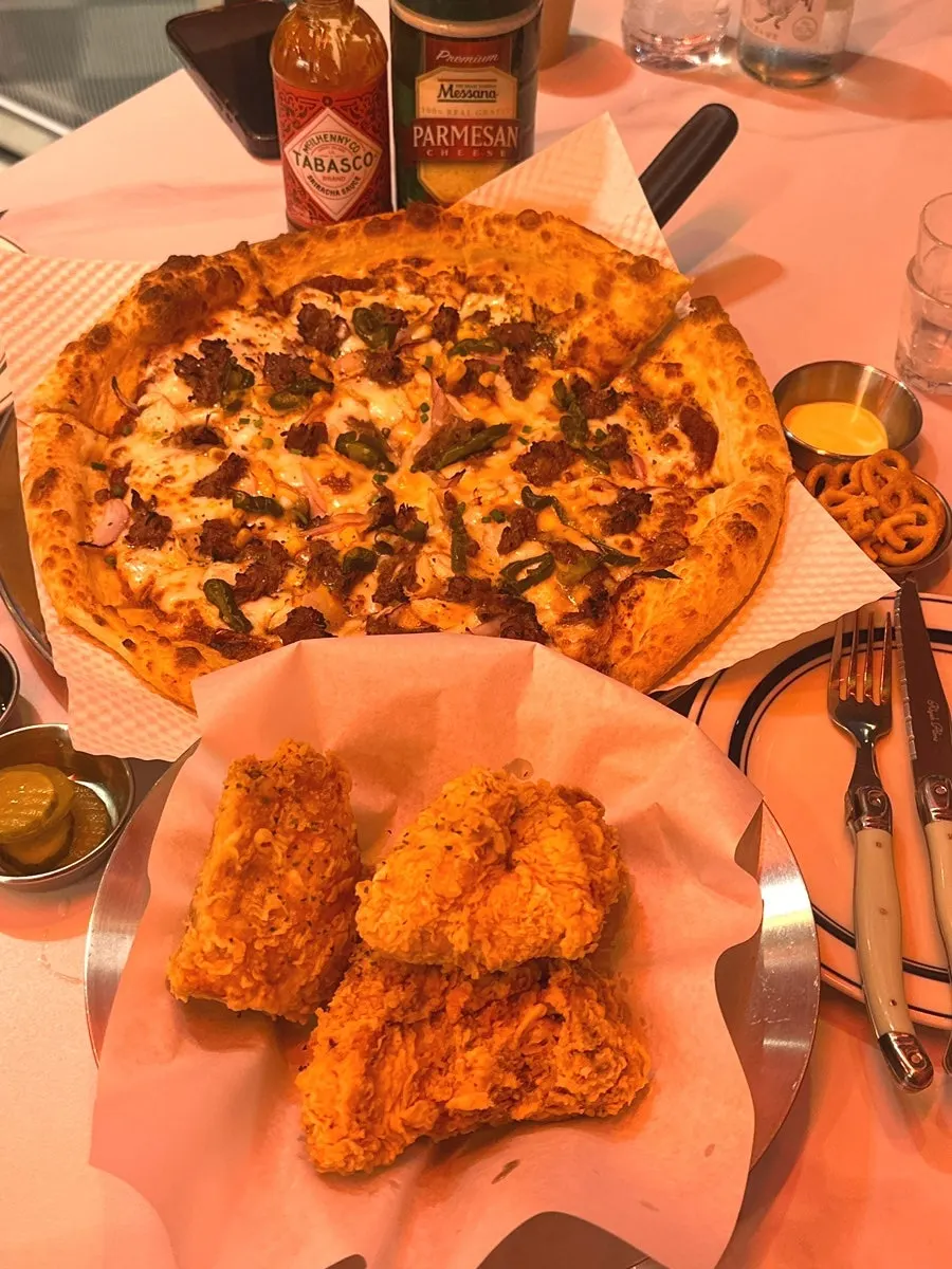 Ordered pizza, chicken, and zero cola spread on the table