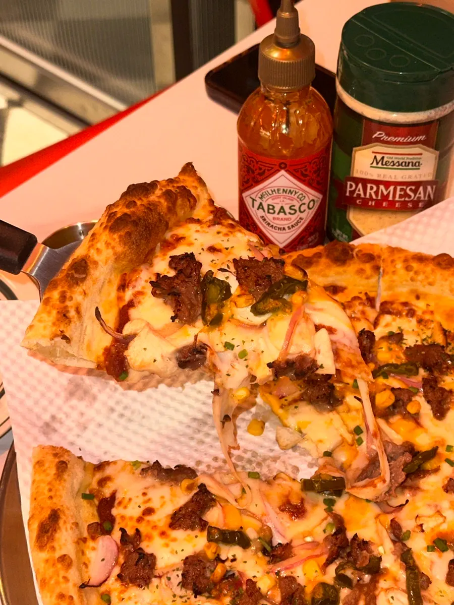 Pizza slice showing the salted butter dough crust