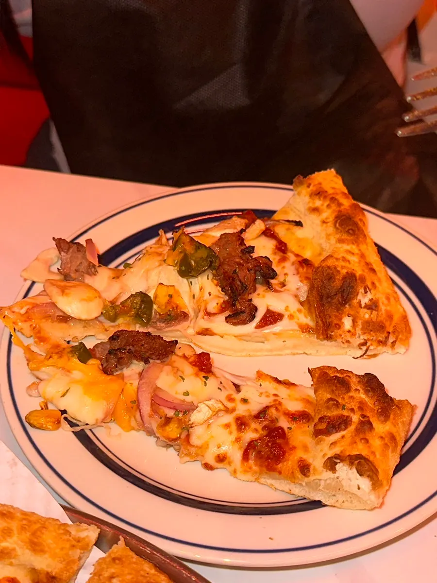 Pizza slice showing bulgogi and jalapeño toppings