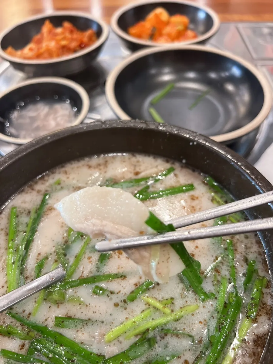 Pork neck meat lifted out of the gukbap
