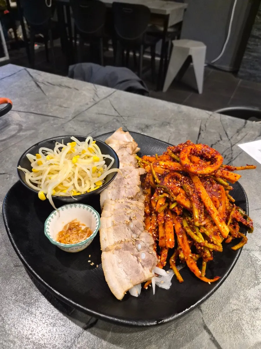 Full spread of bossam and vinegared squid salad in the bossam set