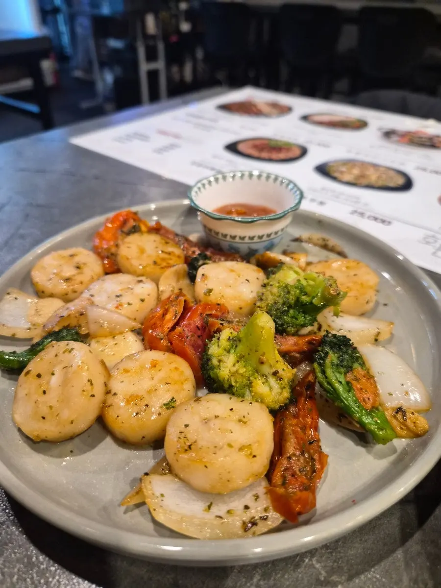 Close-up of plump, browned scallops