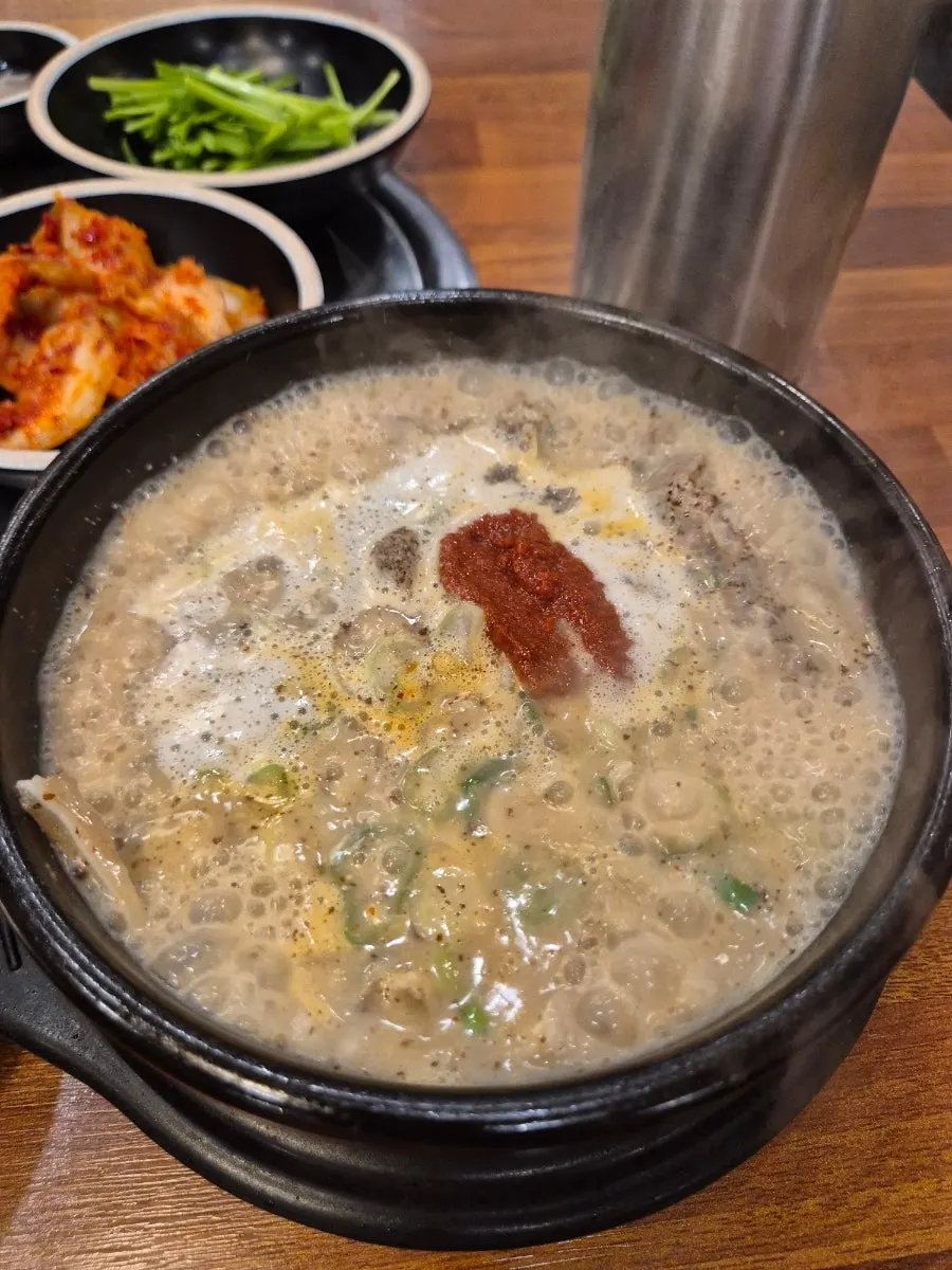 Sundaeguk-bap served in a bubbling stone pot