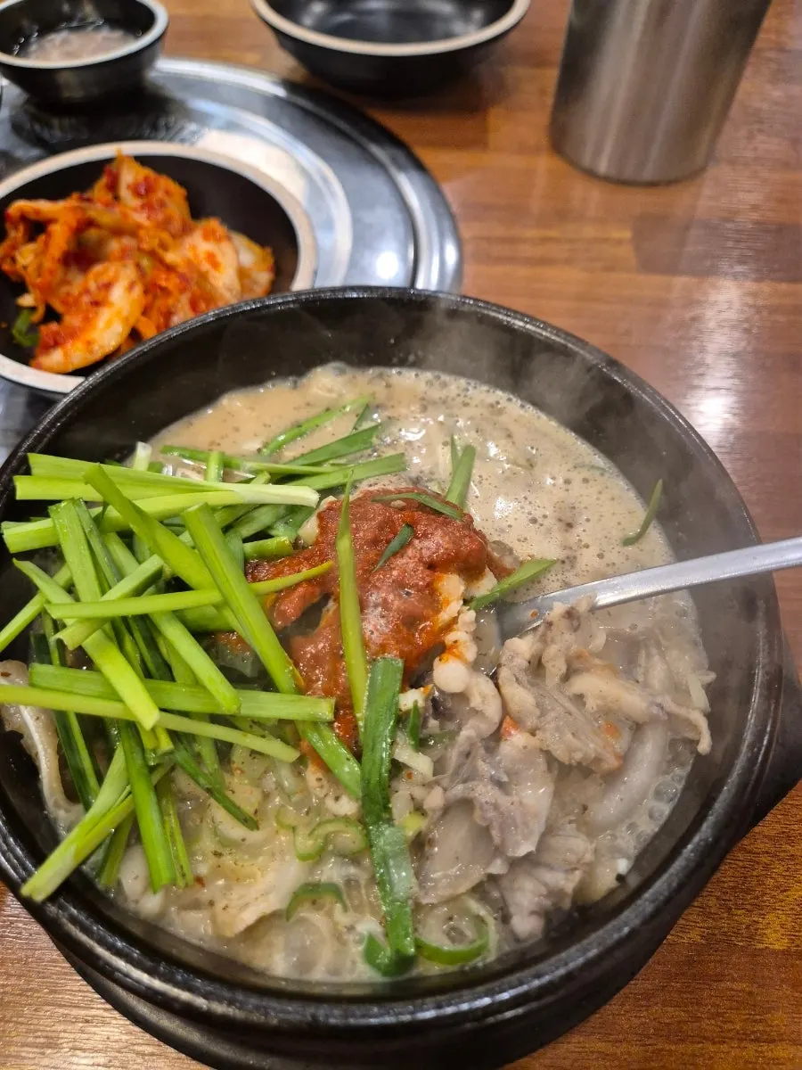 A spoonful of sundaeguk-bap with rice mixed in