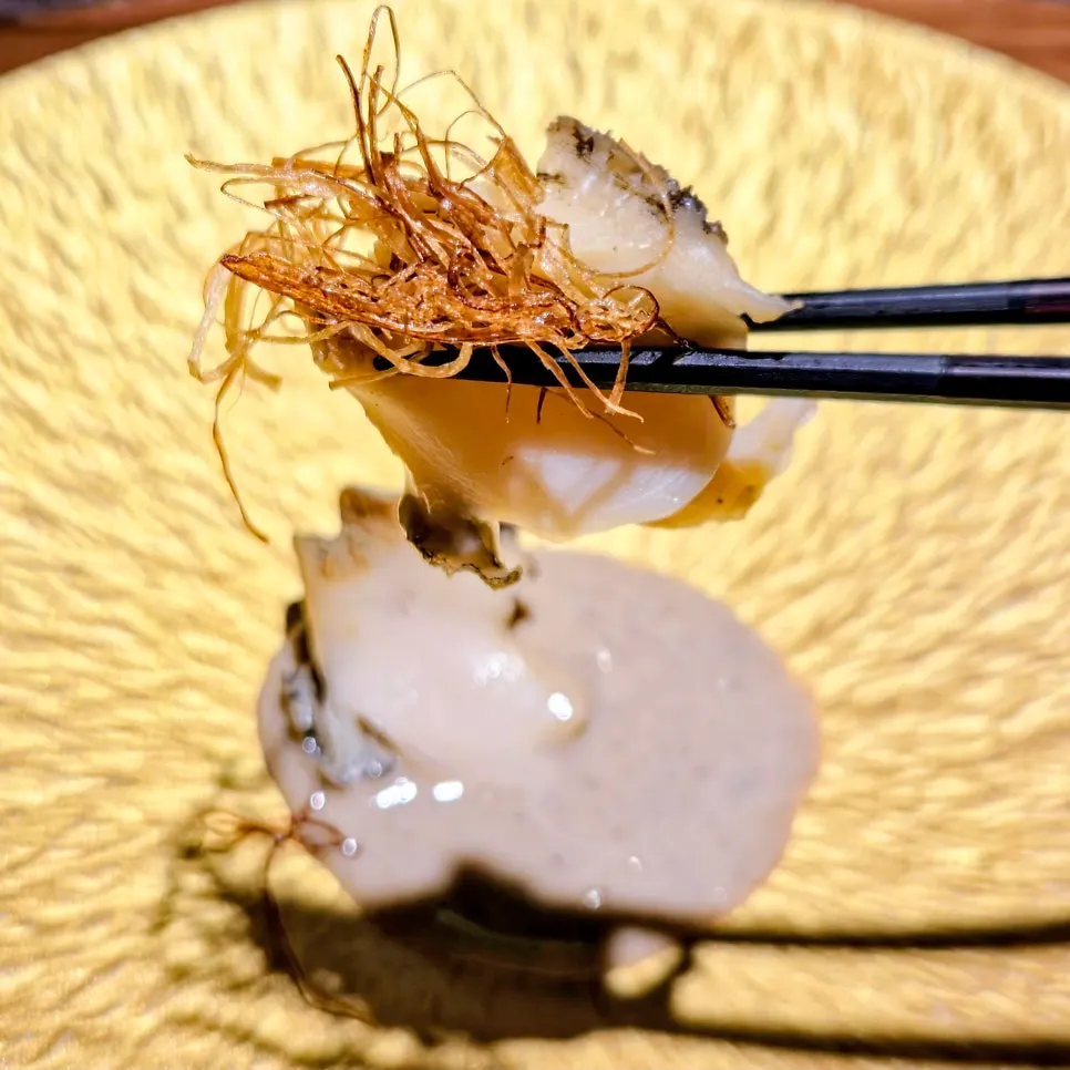 A plate of steamed abalone topped with sauce