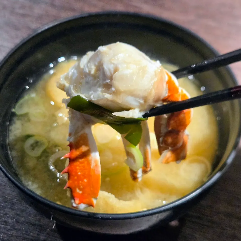 Warm soup served alongside the course