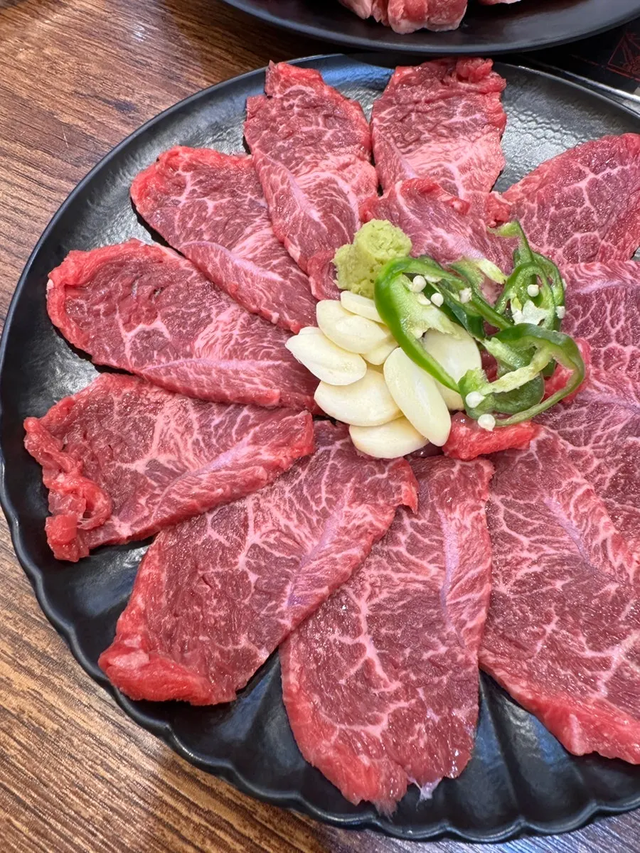 Table spread with yuksashimi and the assorted platter