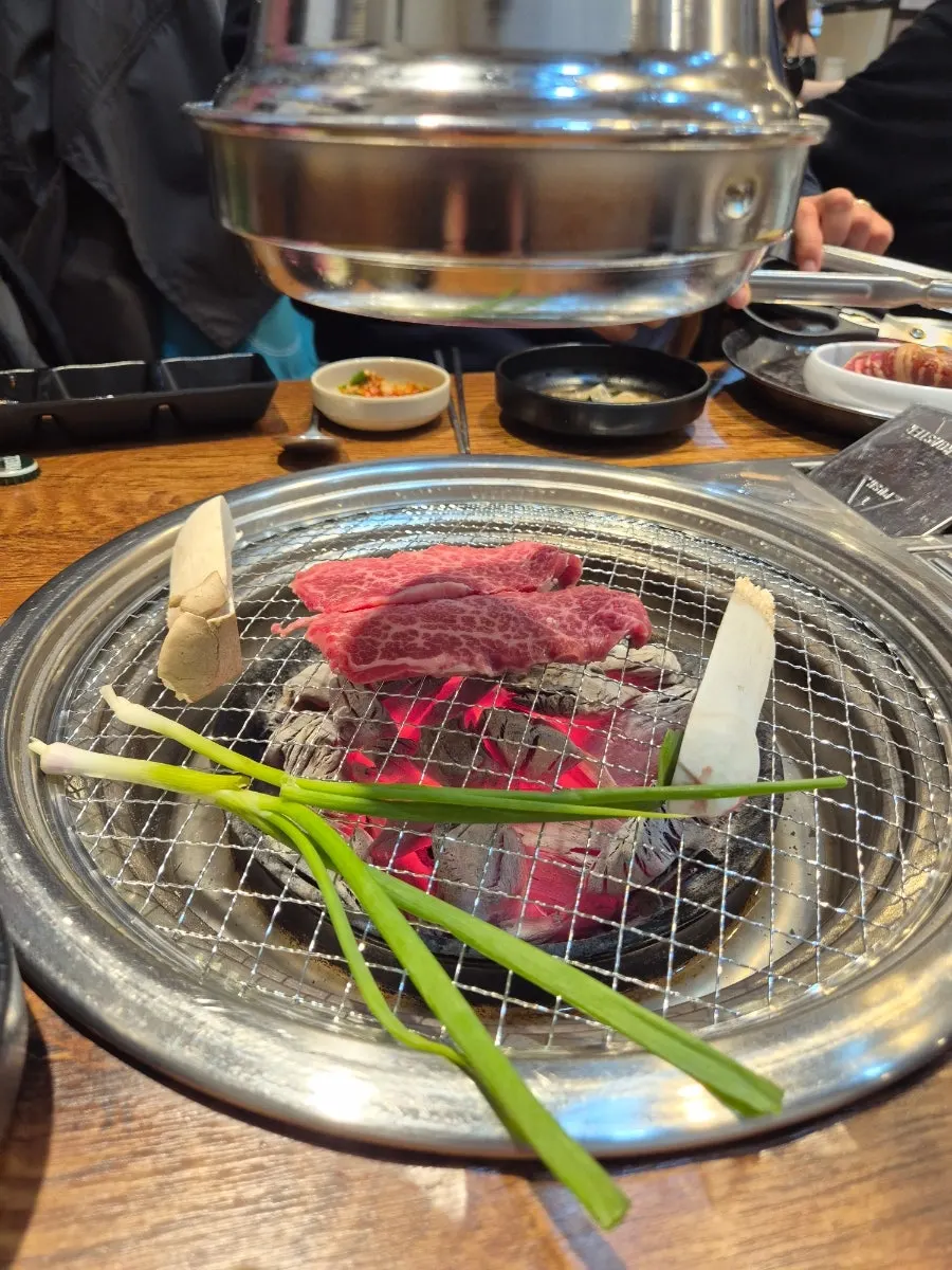 A glass of somaek and a piece of meat