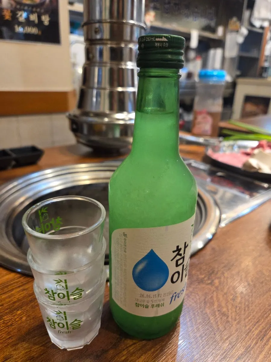 Side dishes and soju set out on the table
