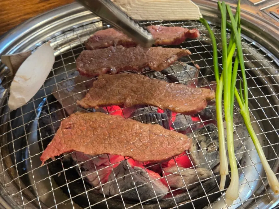 Beef and green onion on the grill plate