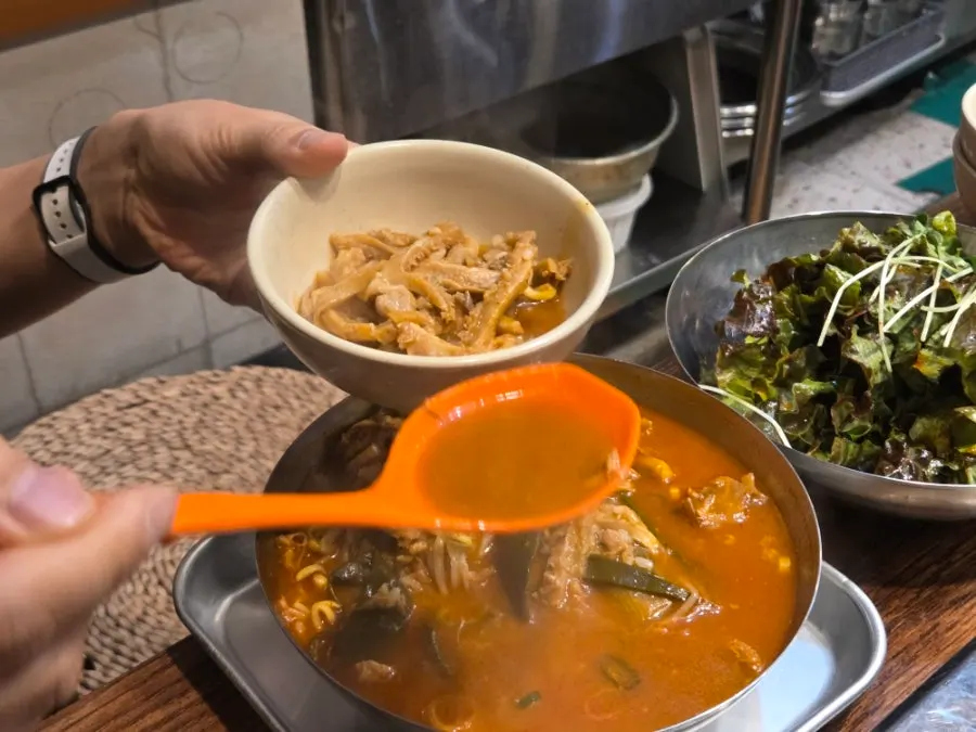 Tripe soup served in a large metal pot at Usijang Hoegwan