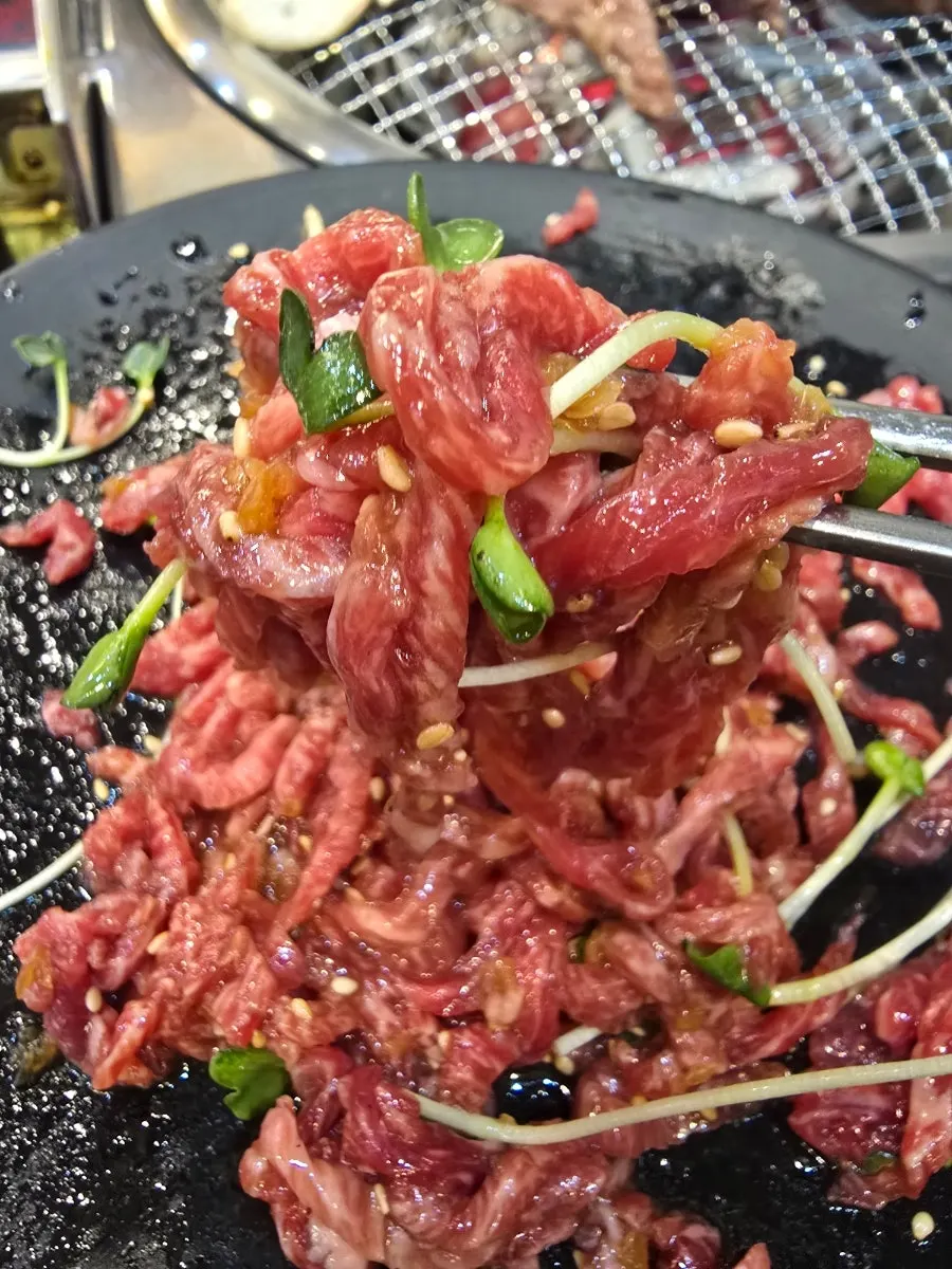 Kkuritsal yukhoe mixed with a burst egg yolk