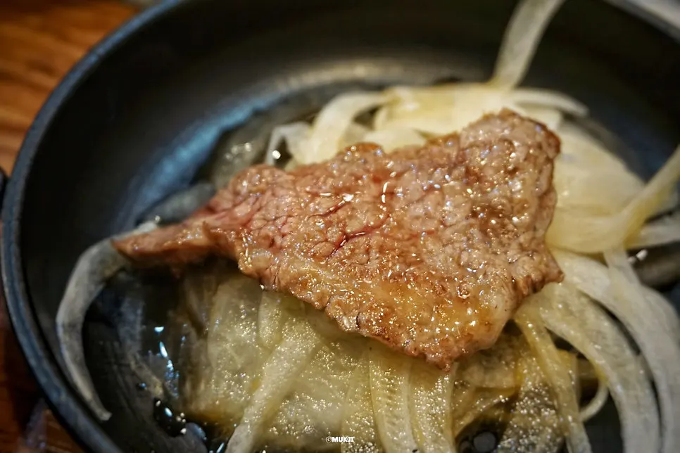 Seasoned LA galbi grilling over charcoal