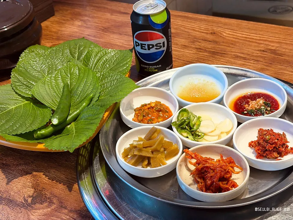 Vegetables and seasoned greens served alongside yuksashimi