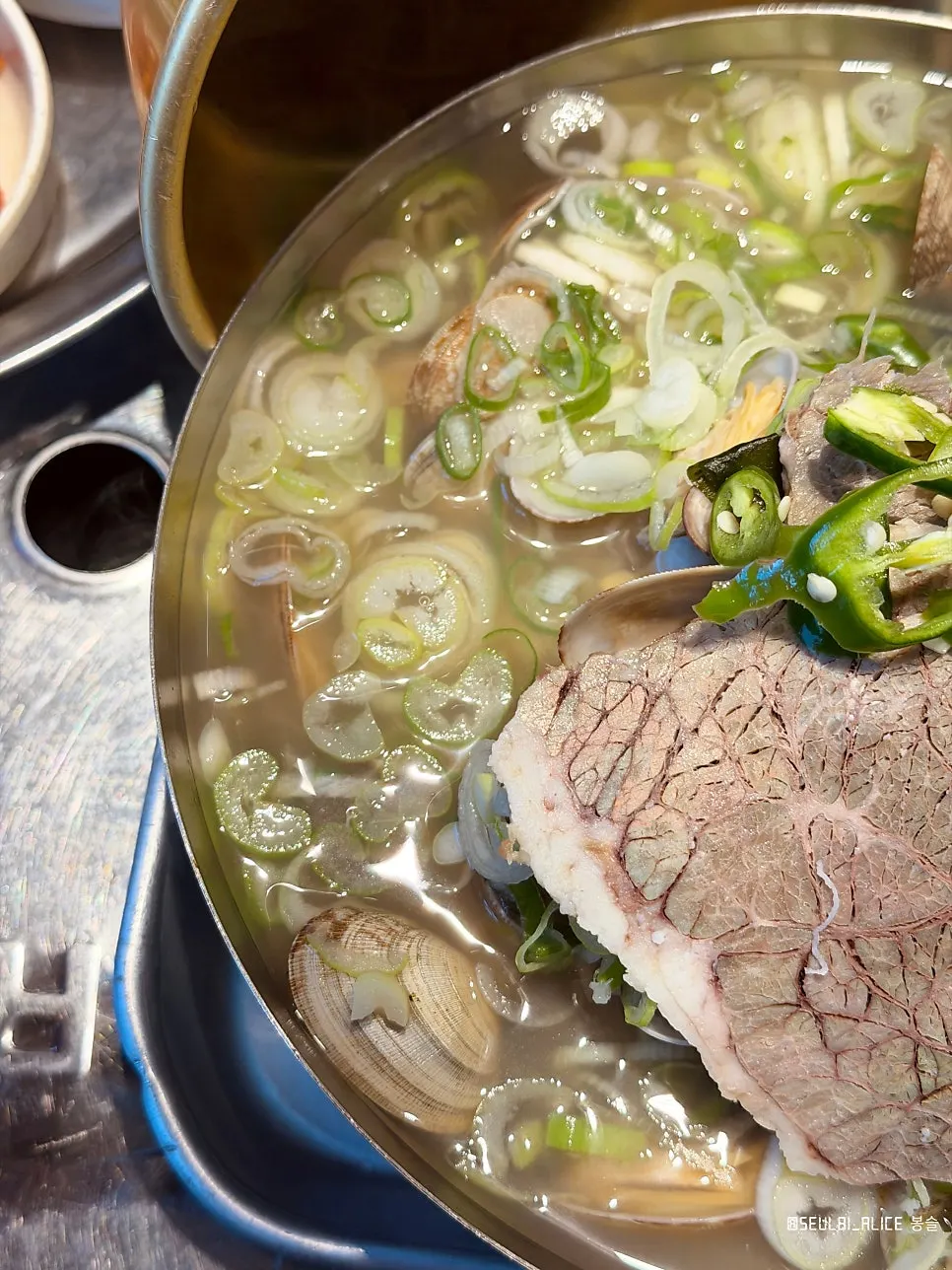 A spoonful of broth and rice from the gukbap