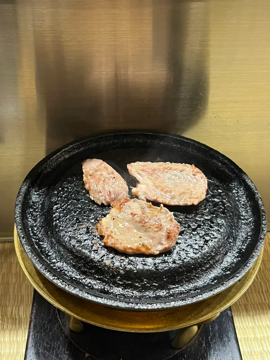 Three pieces of yakiniku on the grill