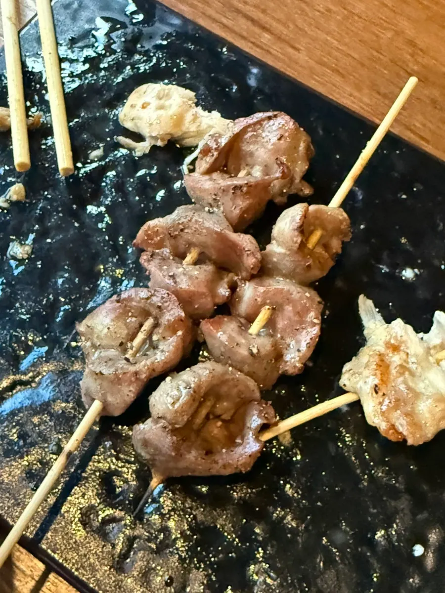 Evening table with yakitori and drink glasses