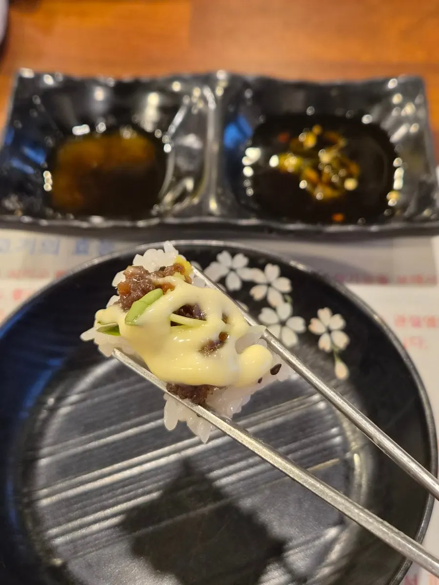 A plate of sushi topped with cooked horse meat