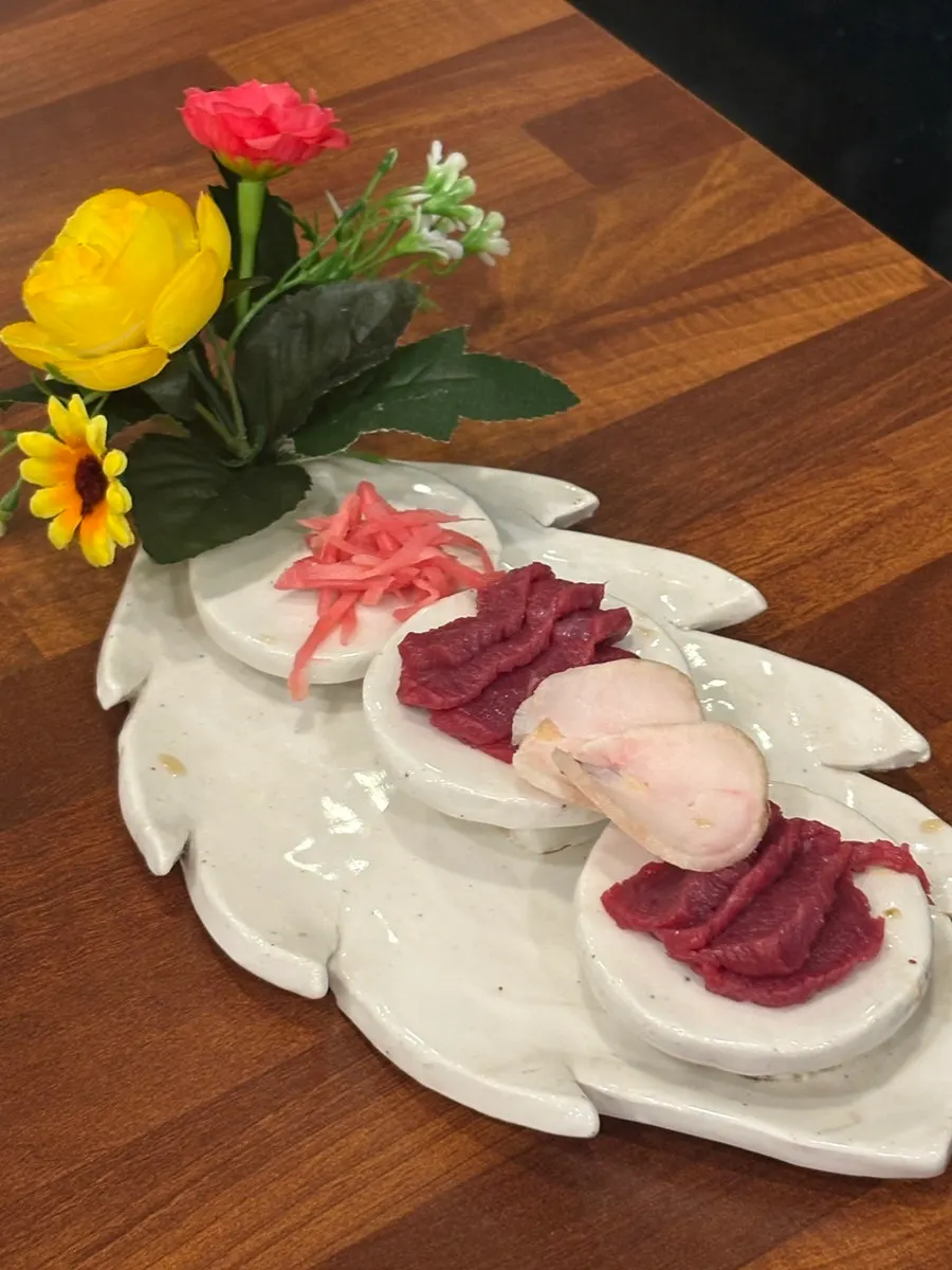 Bright red horse sashimi with sesame oil dipping sauce