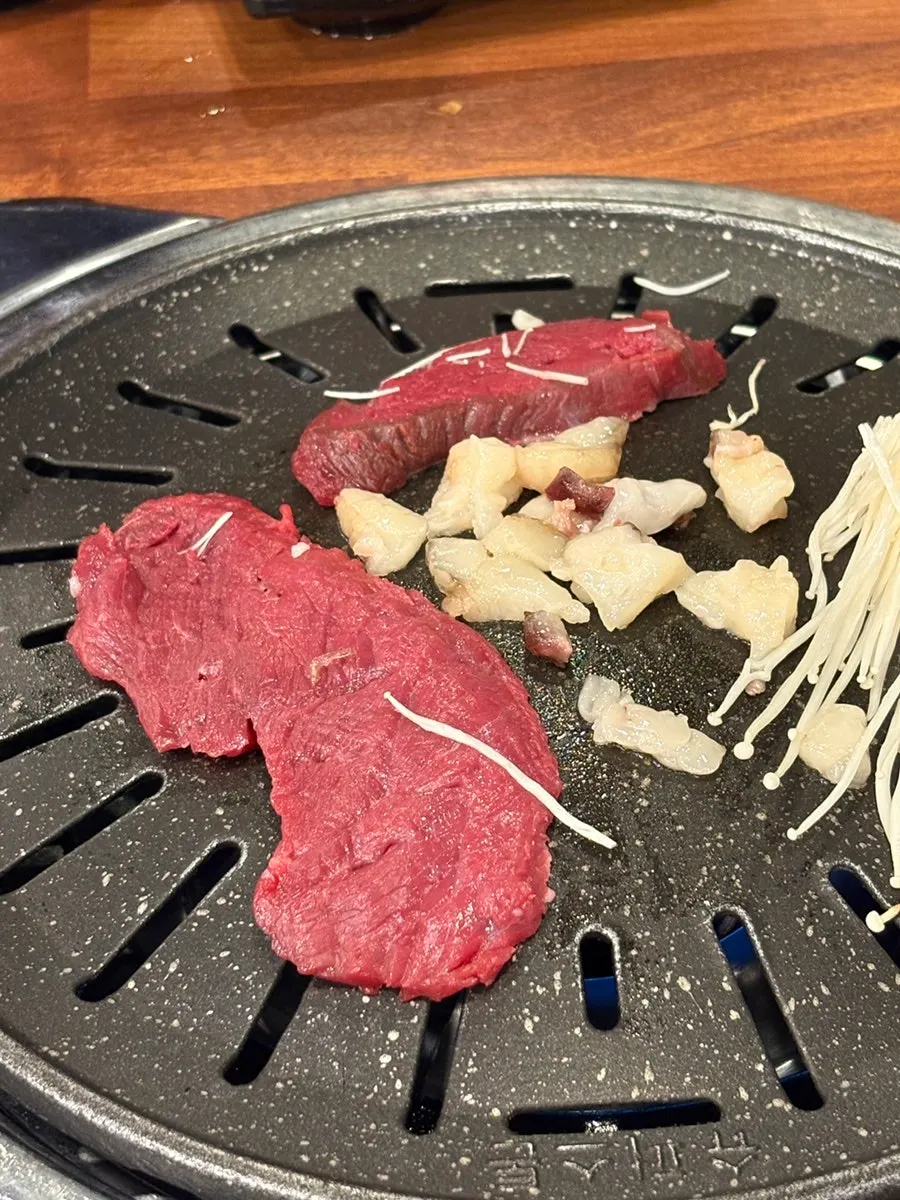 Grilled horse meat and horse fat oil on the grill