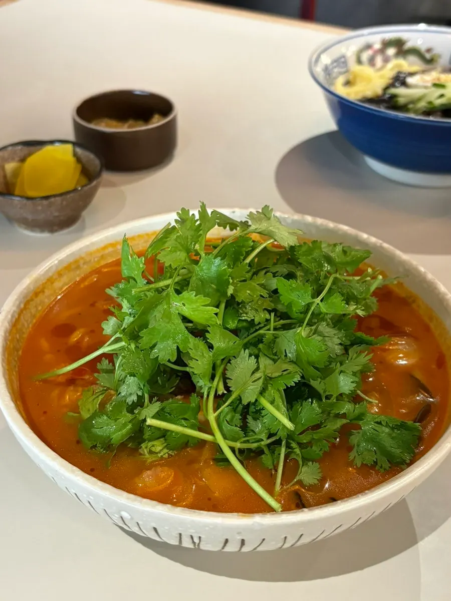 Mala gochu jjamppong topped with beef and cilantro