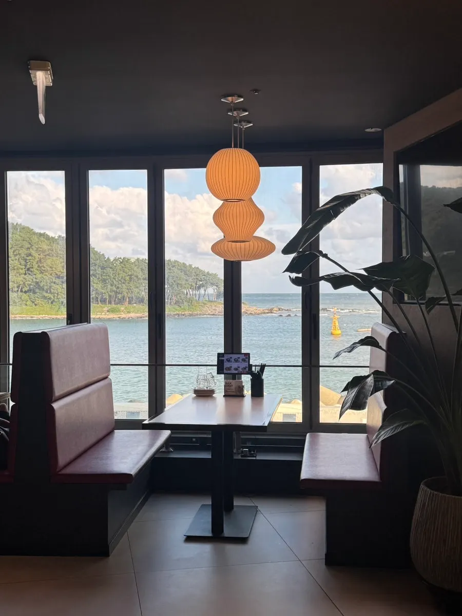 Ocean-view sofa seating and restaurant interior