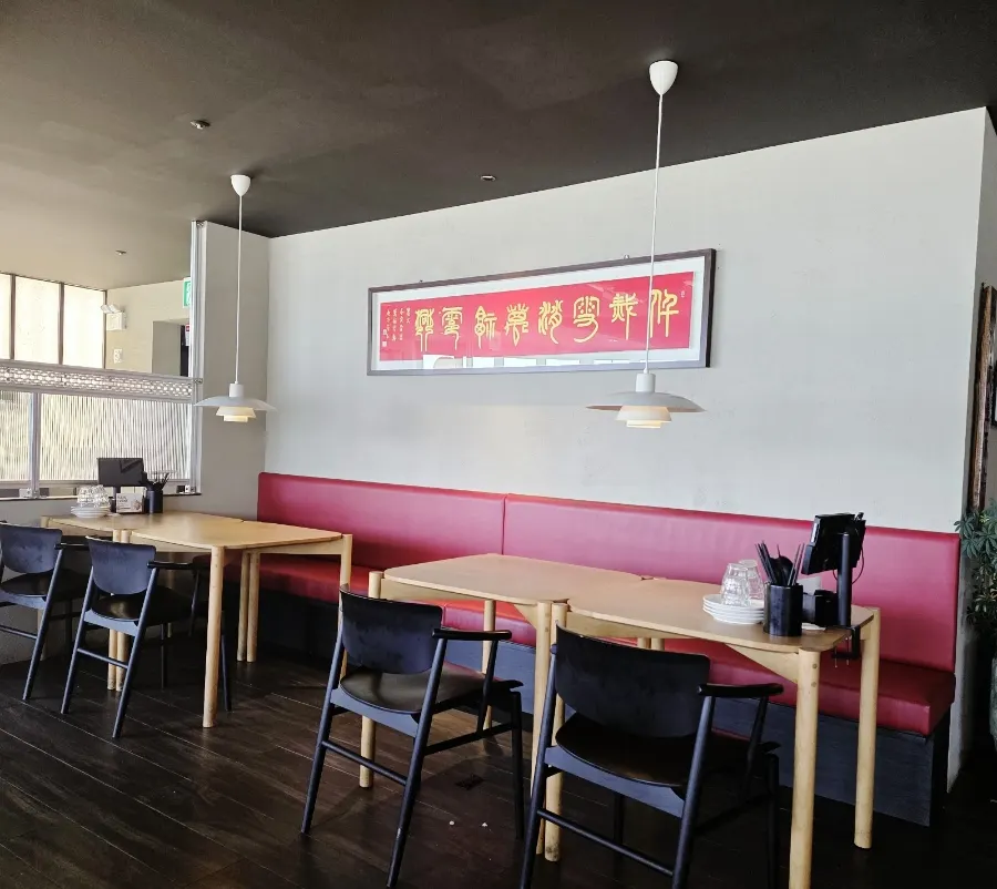 A generous spread of Chinese dishes by the ocean-view window