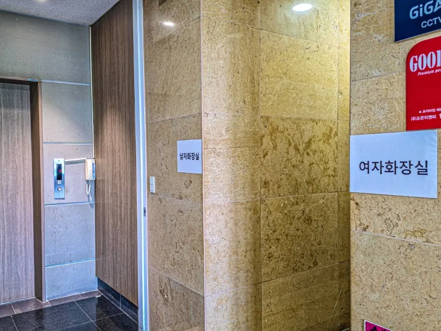 Separate men's and women's restrooms on the same floor outside the restaurant